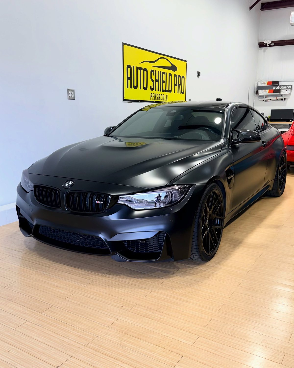 Matte black film along the fender, door and sill edges of a BMW M4